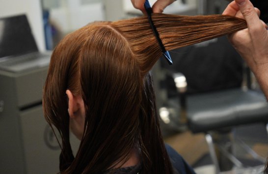 Colour treatment being applied to long hair